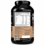 Back view of QNT 100% Isolate Protein for Ripped Body, Coffee flavor whey protein isolate supplement container showing nutrition facts, ingredients, serving information, and barcode.